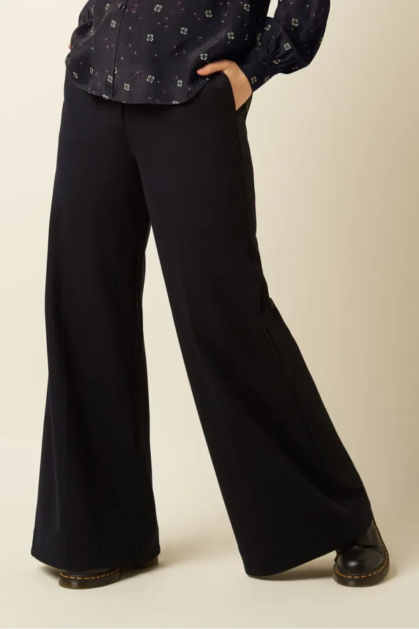 Die Chloe Pants Uni Rodeo haben eine mittlere Taille mit Gürtelschlaufen, Seitentaschen und falschen Paspeltaschen hinten. Aus gewebter Viskose mit Stretch gefertigt, mit weitem Bein und Haken- sowie Reißverschluss. Erhältlich in normaler und petite Länge – für perfekte Passform und stylischen Komfort. Farbe schwarz